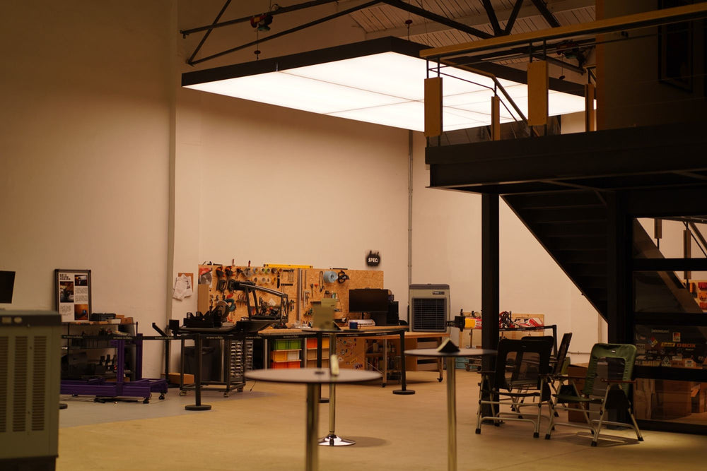 The studio floor in the evening, with the mezzanine and its stair on the right