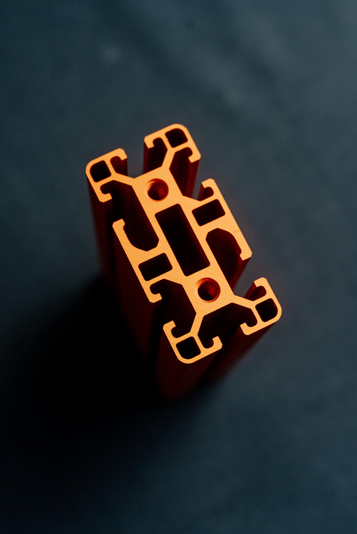 Cut end of a SPEC 40 Series aluminum extrusion showing double T-slots and two center bores