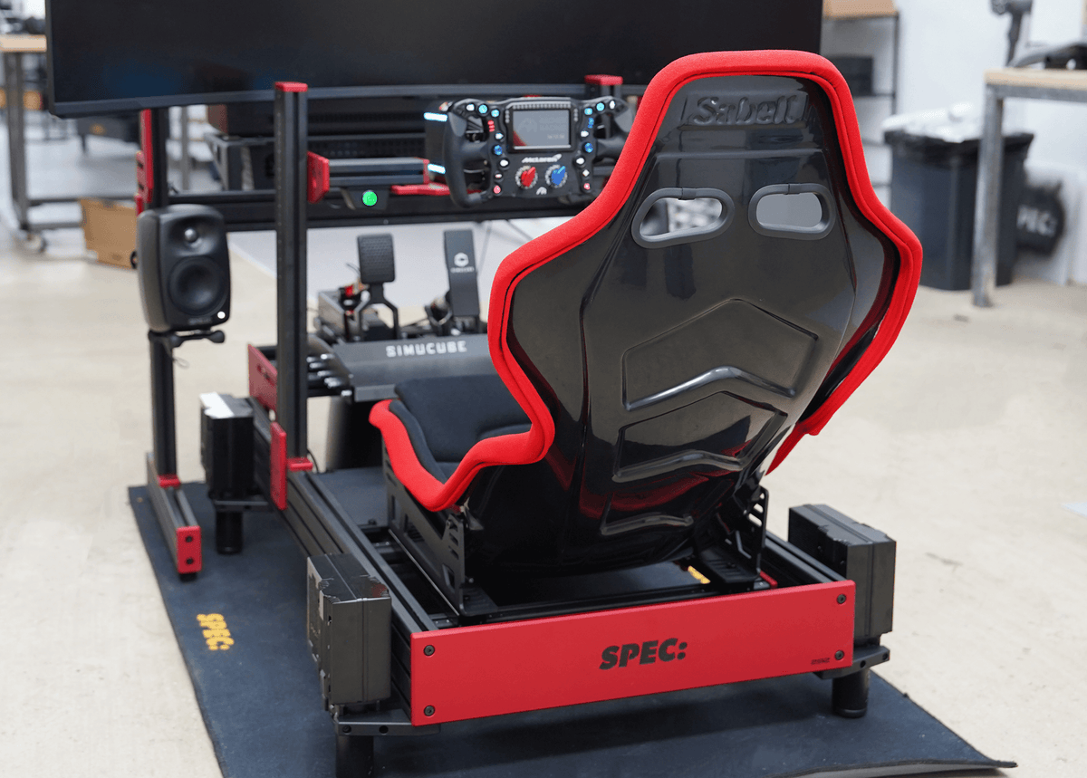 SPEC 282 sim rig, red frame with black seat, Simucube wheelbase, workshop