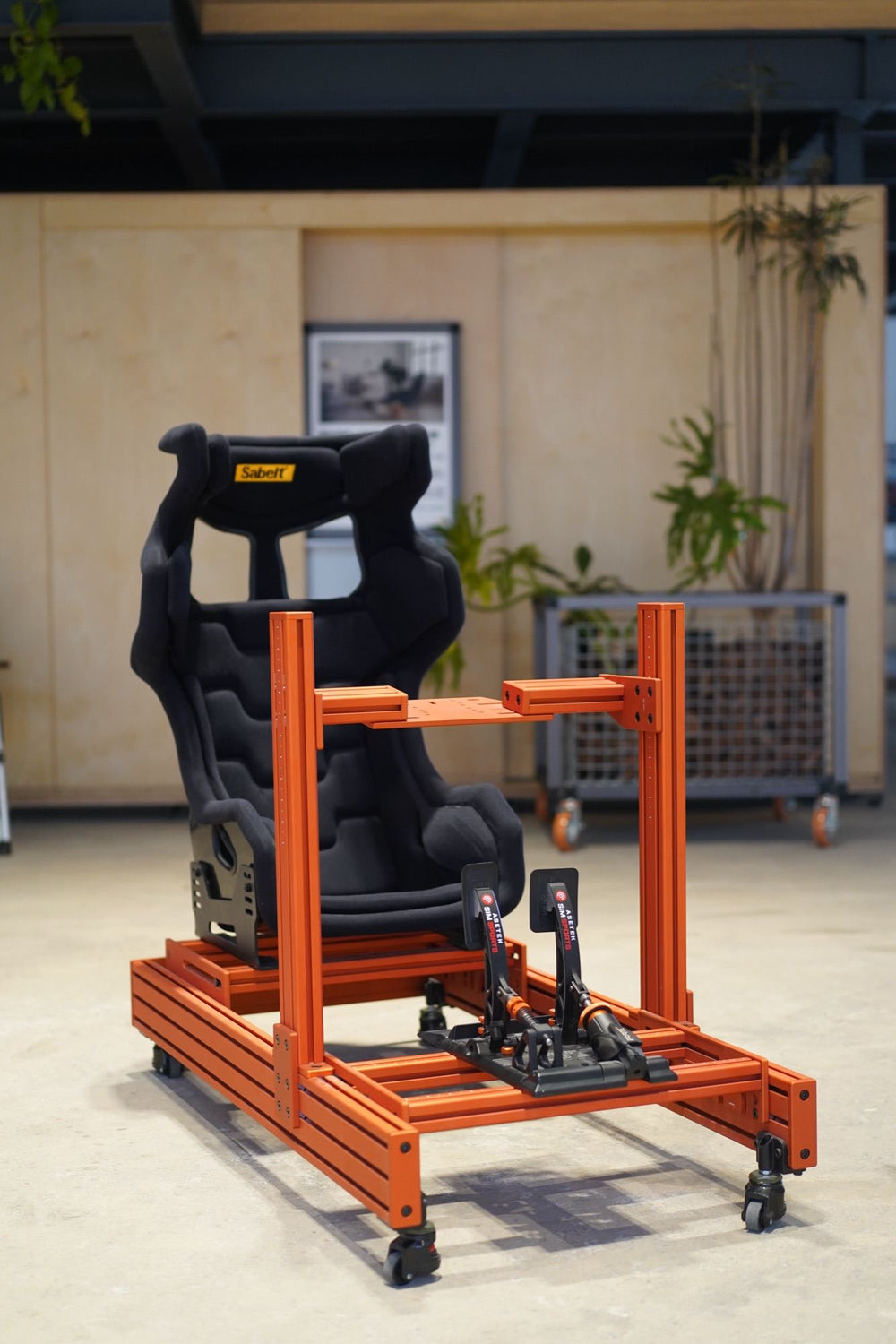 An orange SPEC 282 with a black seat on the studio floor