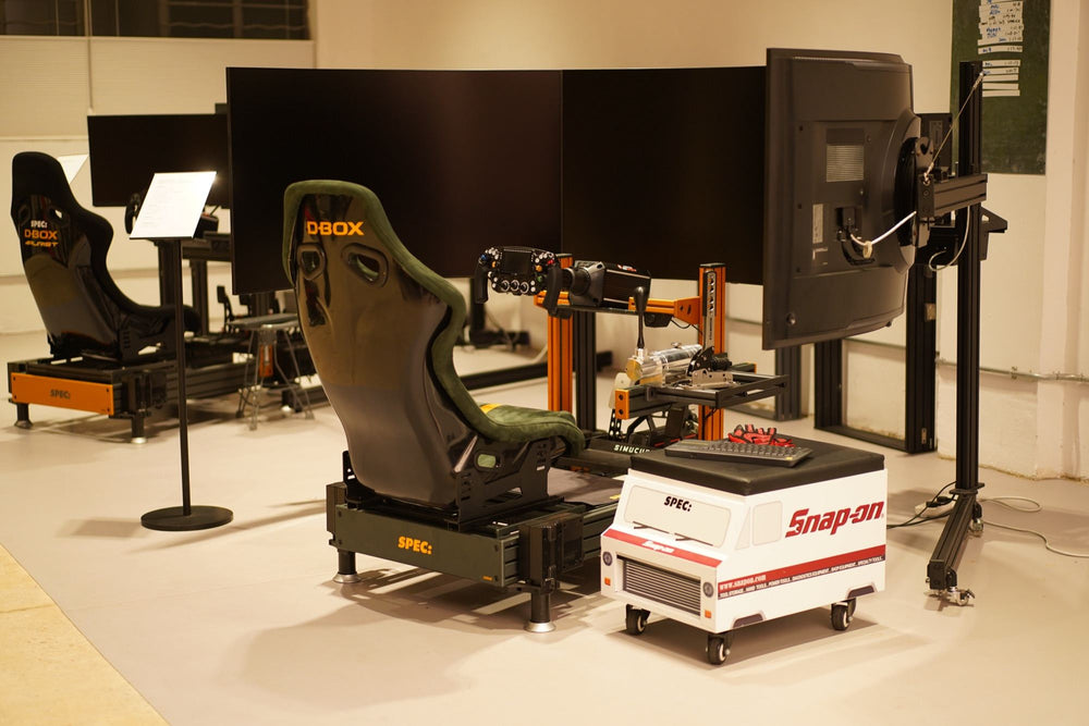 Two D-BOX motion rigs with triple screens set up in the studio