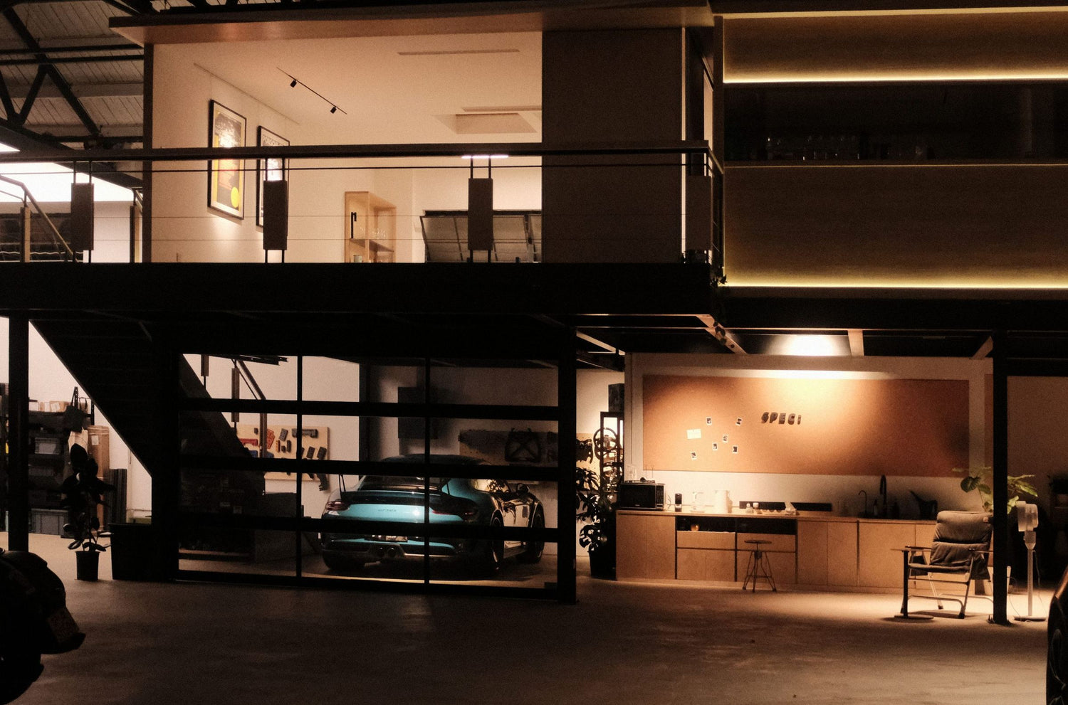 The SPEC studio in Shanghai at night: a mezzanine above a workshop floor, a blue sports car, and a cork wall with the SPEC sign